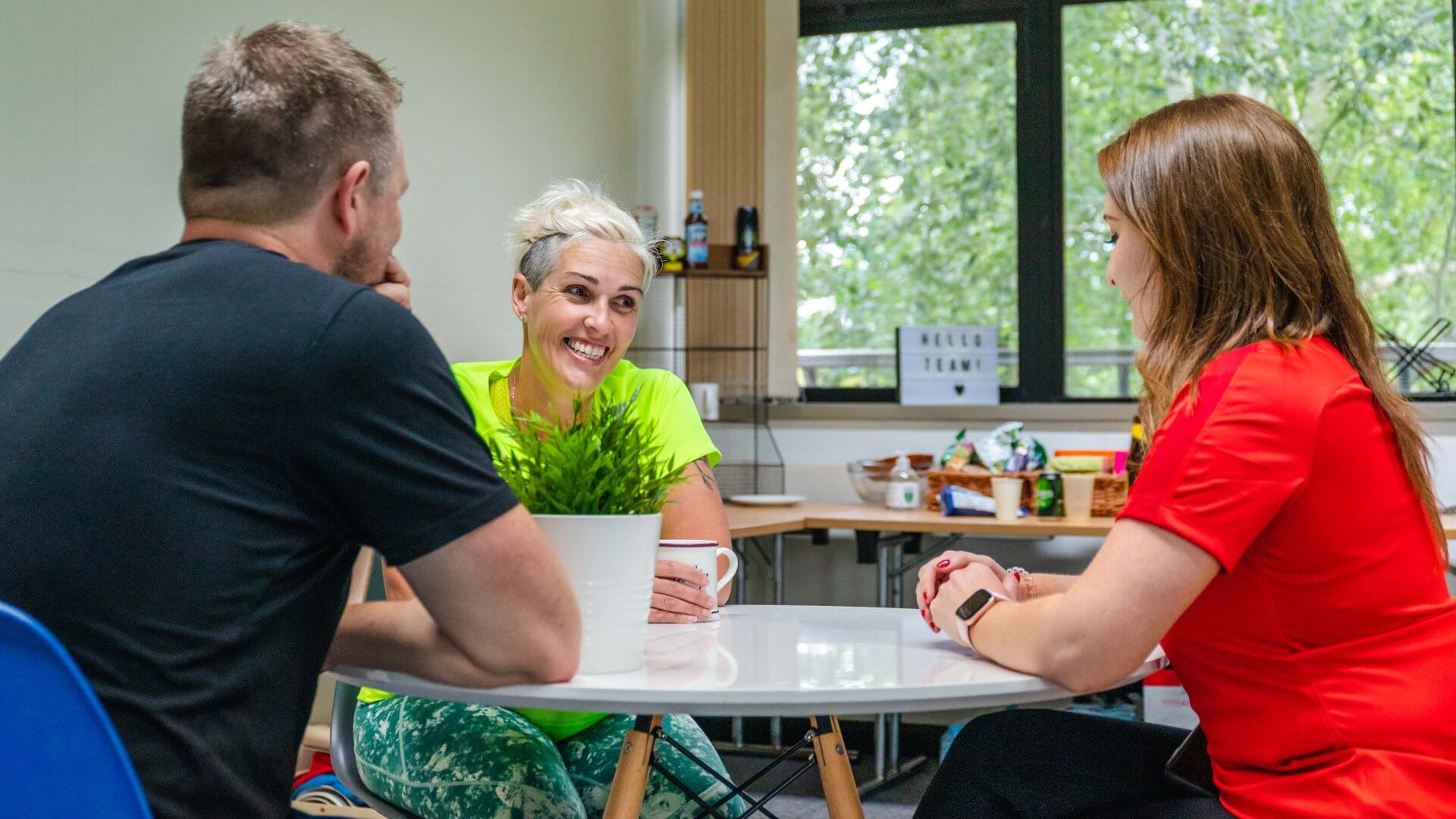 The Organic team sat around a table in a meeting.